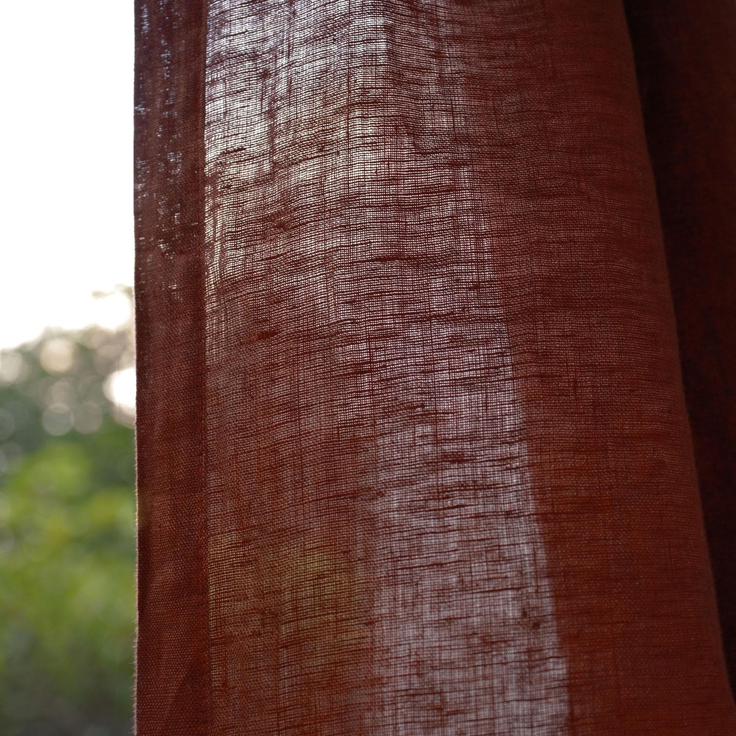 alternate angle of Motif Linen Noren — Mist Red hanging as a two-panel doorway curtain