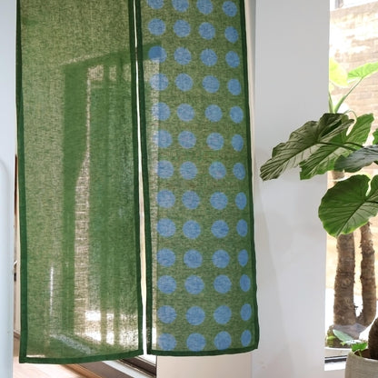 alternate angle of Polka Dot Linen Noren — Green / Dots hanging as a two-panel doorway curtain