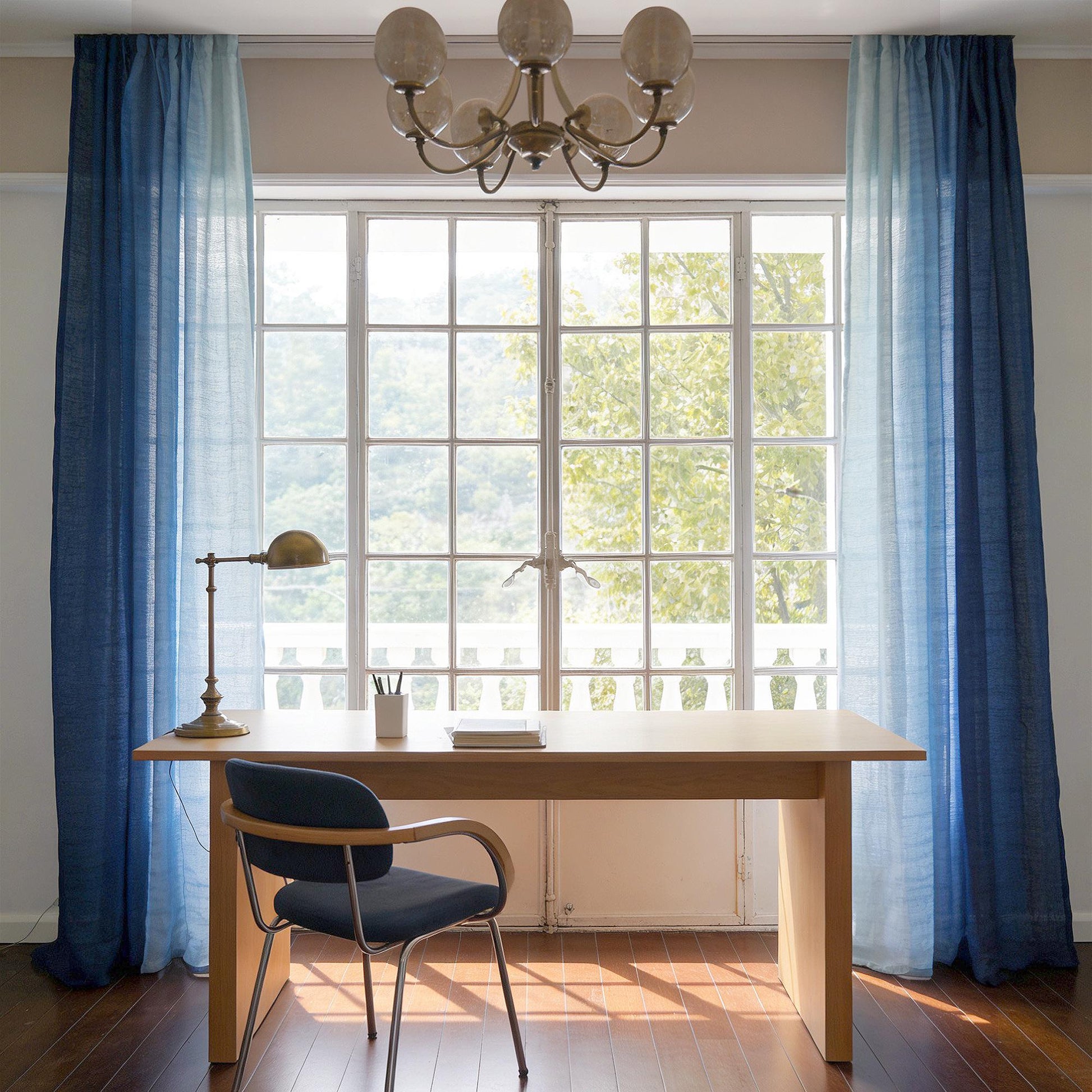 Linen Panel — Soft Blue hanging by a window, filtering daylight in a styled interior