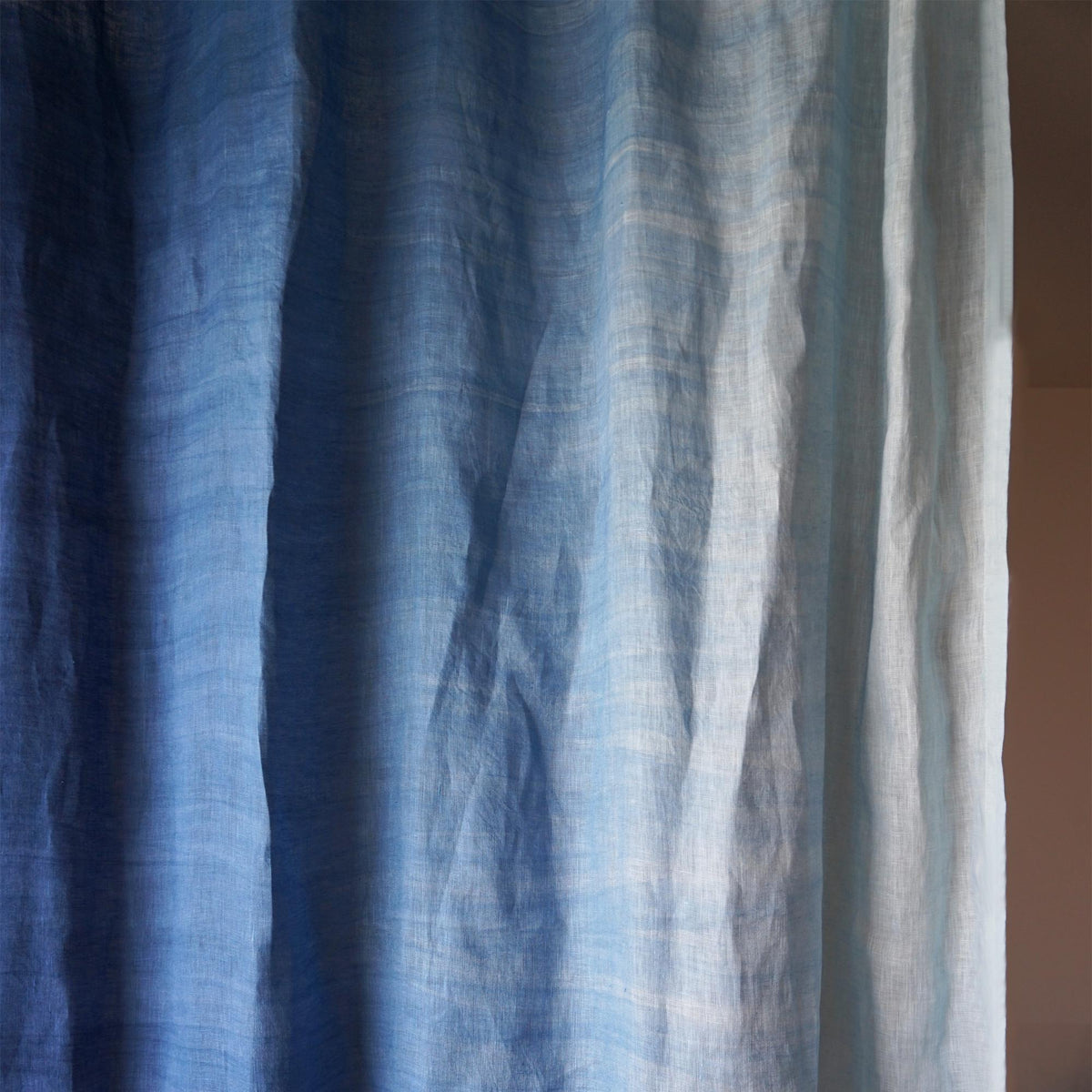 room scene with Linen Panel — Soft Blue used as sheer curtains in a living space