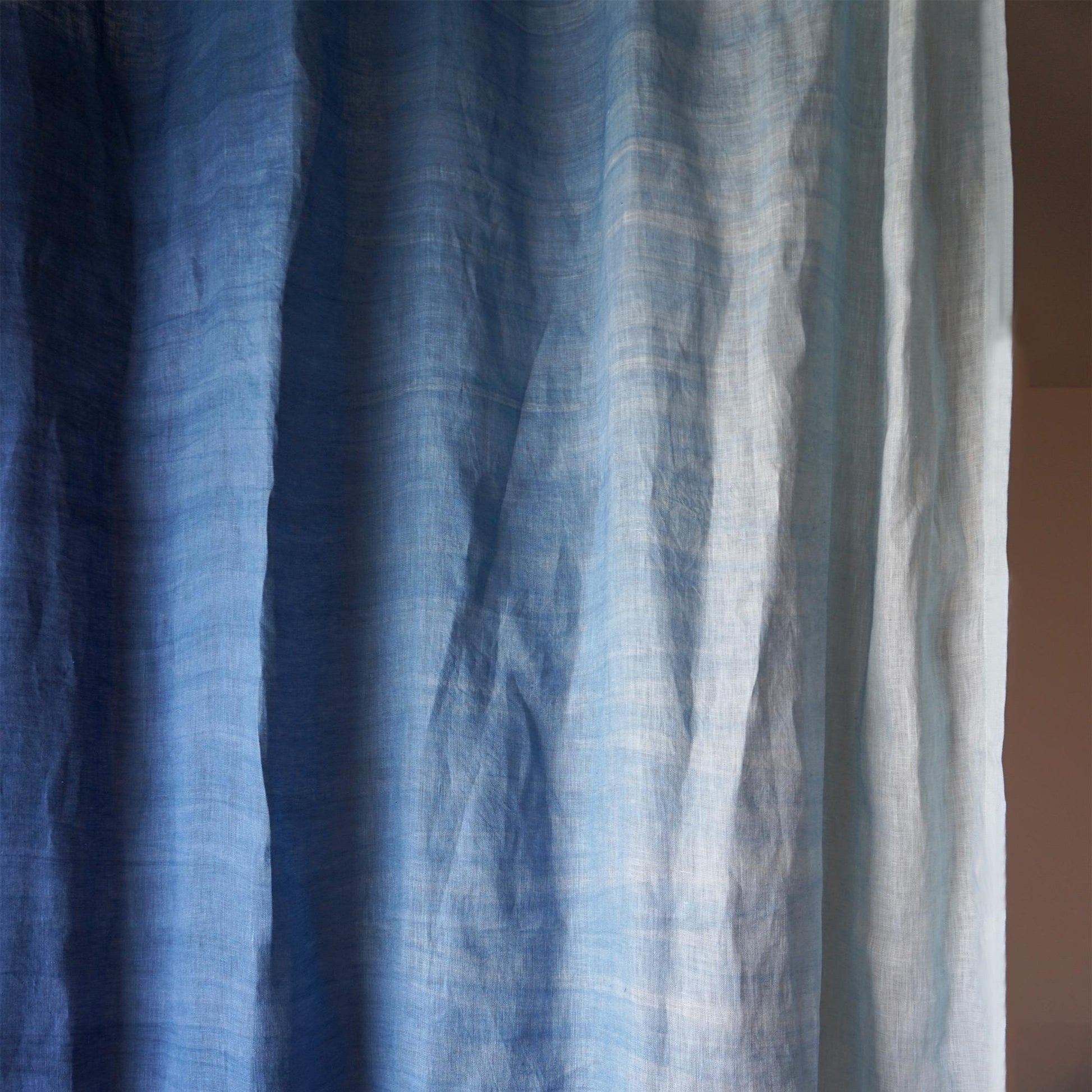 room scene with Linen Panel — Soft Blue used as sheer curtains in a living space