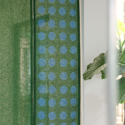 alternate angle of Polka Dot Linen Noren — Green / Dots hanging as a two-panel doorway curtain