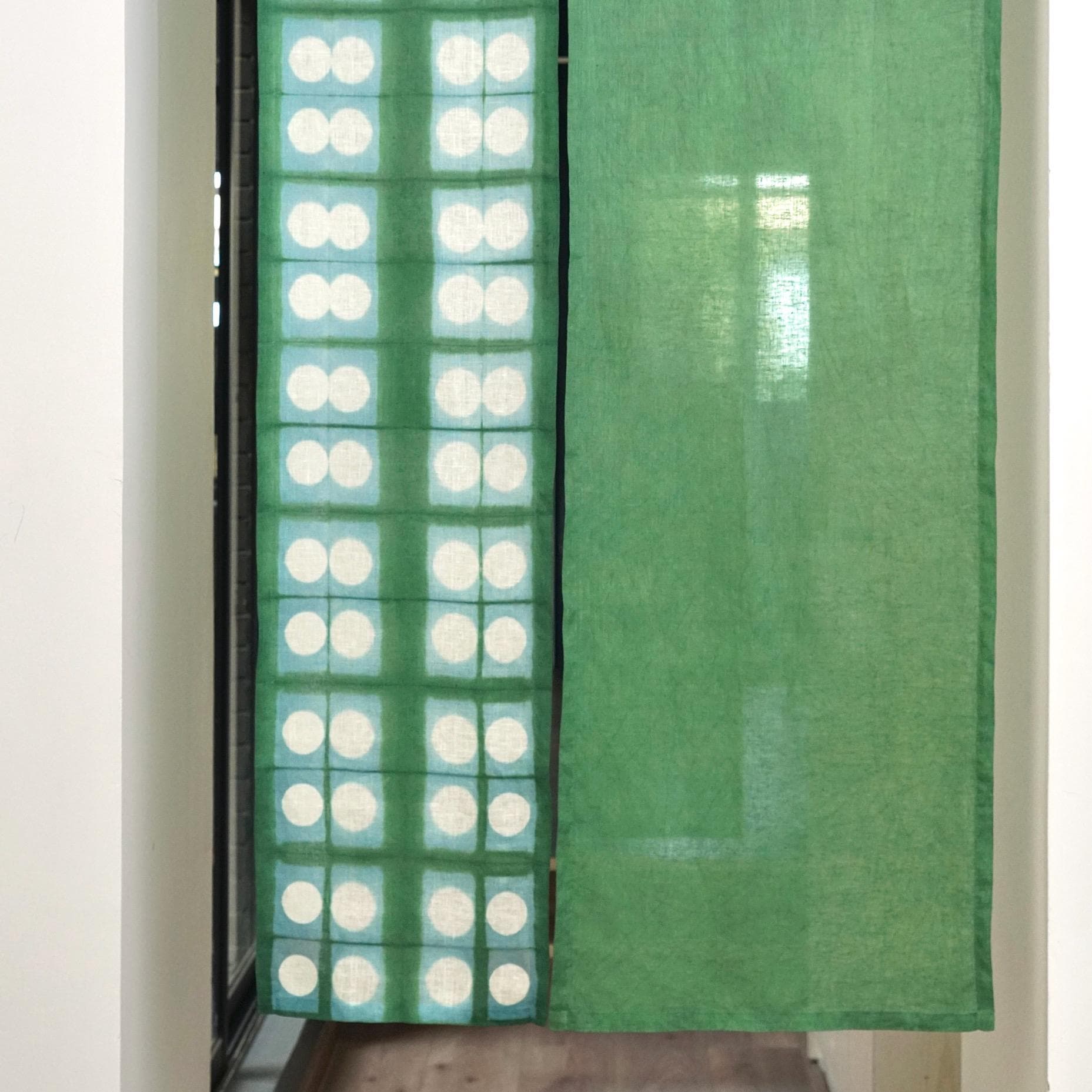 styled room scene with Motif Linen Noren — Soft Moss used as a window or doorway curtain
