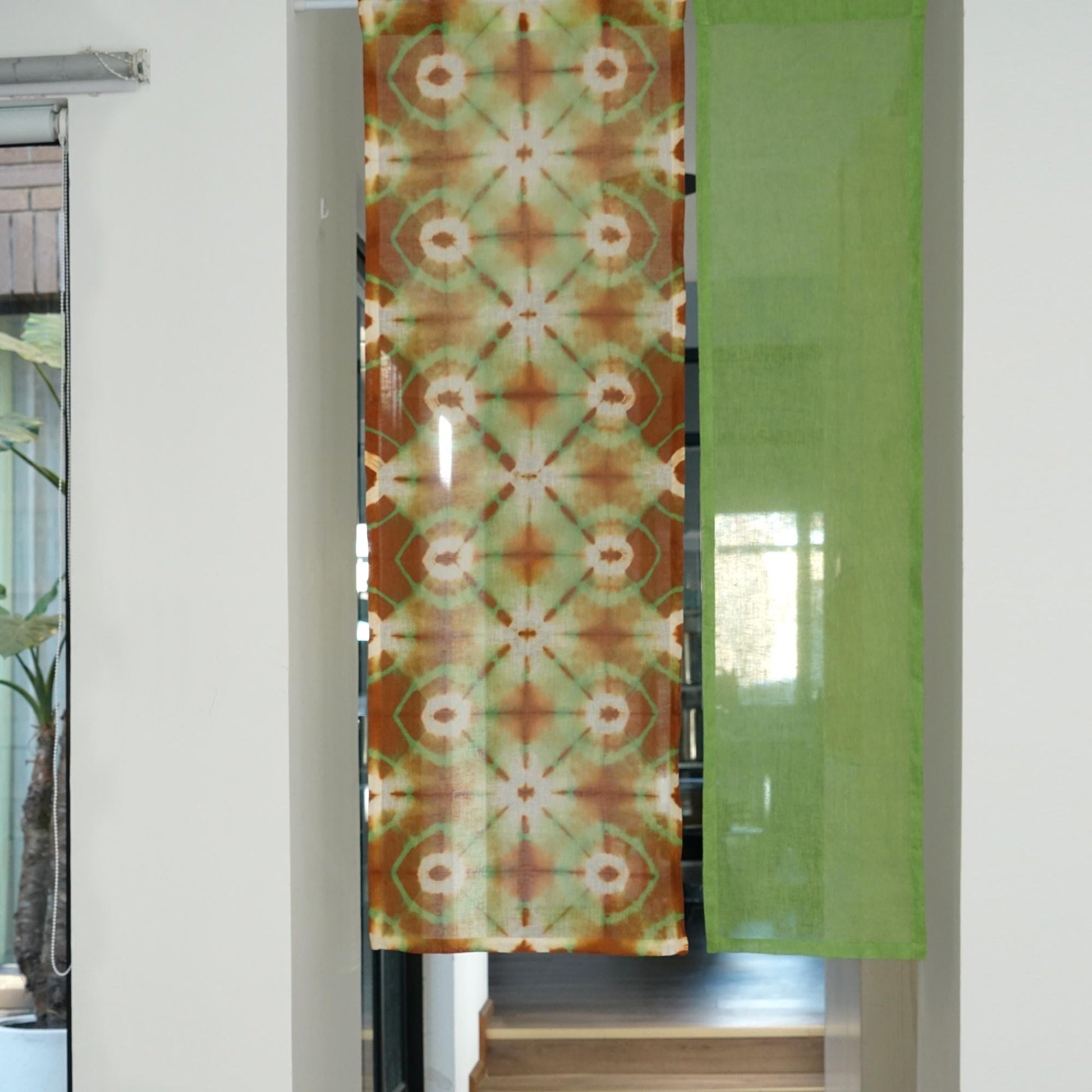 close-up of Motif Linen Noren — Green Bloom showing the natural resist-dye motif on linen