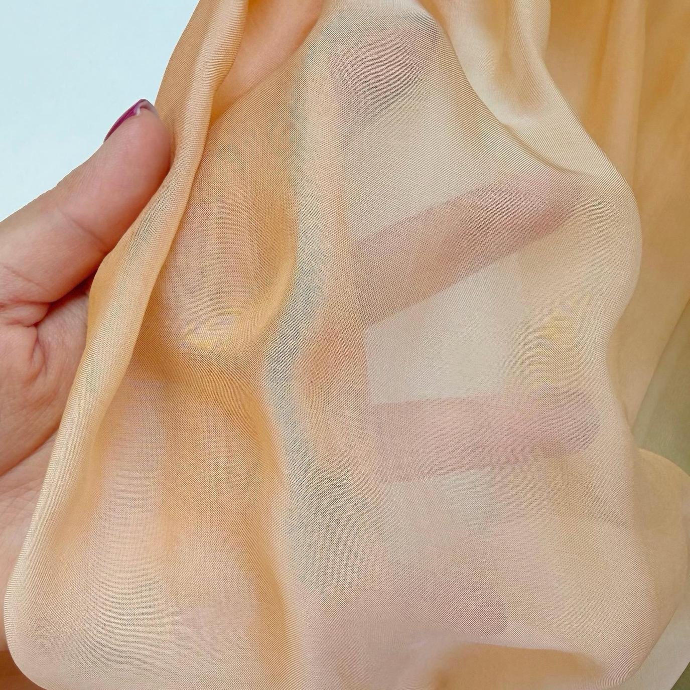 detail view of Sheer Curtain — Orange Green showing natural ramie texture and color