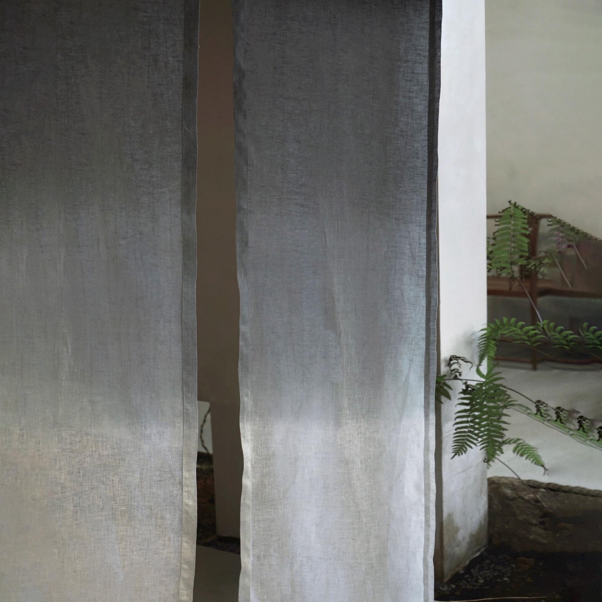 alternate angle of Soft Tone Noren — Ink Grey hanging as a two-panel doorway curtain