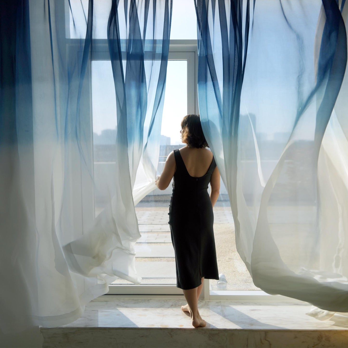 Sheer Curtain — Indigo Flow hung as window curtains in a bright room