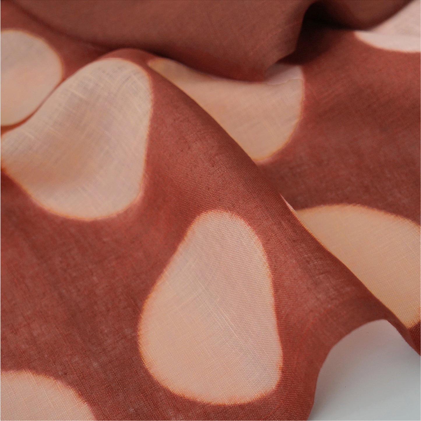 Hand dyed linen noren curtain in pink and red, hanging in a doorway as a room divider