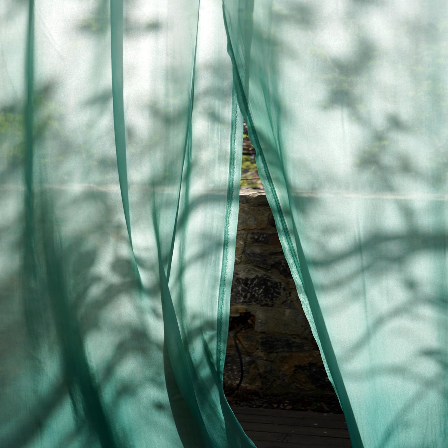 alternate interior view with Sheer Curtain — Emerald Blue filtering soft daylight