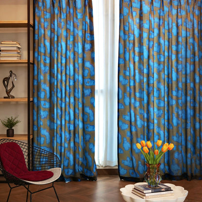 Pattern Drapery — Deep Blue dressing tall windows in a styled living room