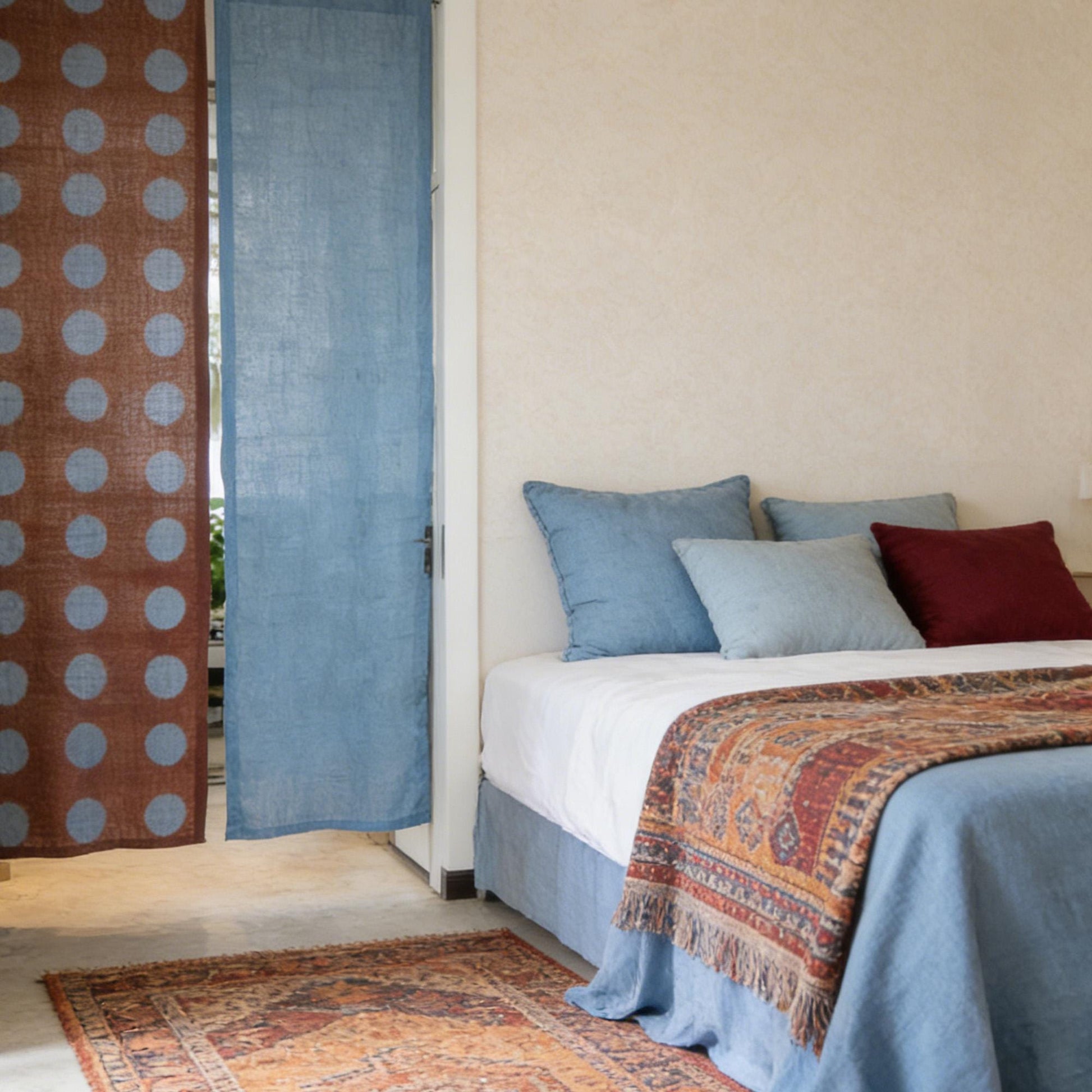 alternate angle of Polka Dot Linen Noren — Rust / Blue hanging as a two-panel doorway curtain