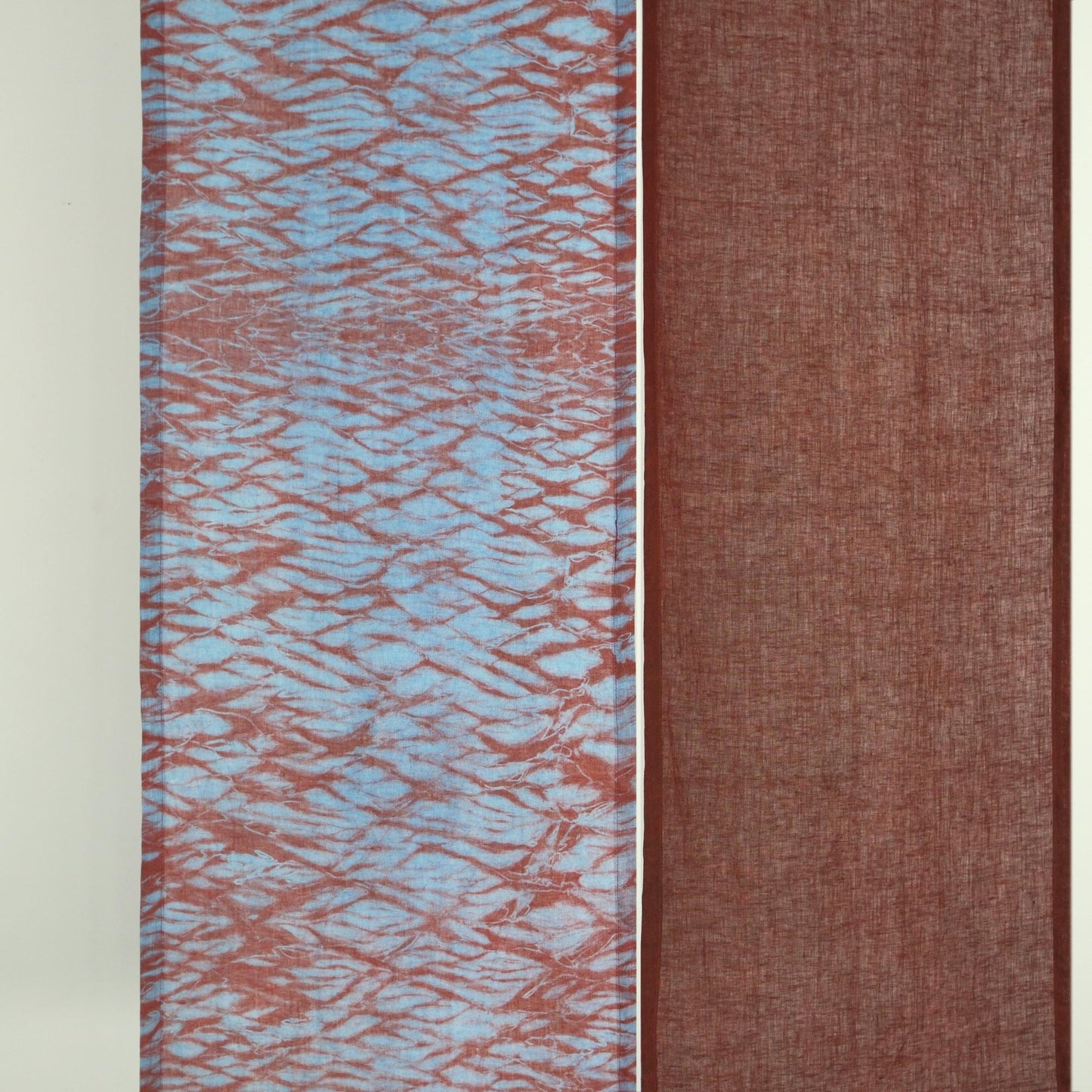 close-up of Motif Linen Noren — Mist Red showing the natural resist-dye motif on linen