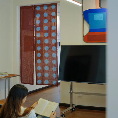 alternate angle of Polka Dot Linen Noren — Brick / Red hanging as a two-panel doorway curtain