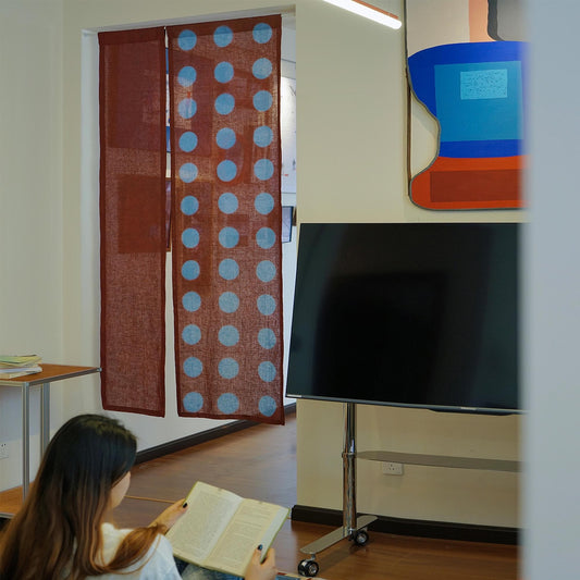 alternate angle of Polka Dot Linen Noren — Brick / Red hanging as a two-panel doorway curtain
