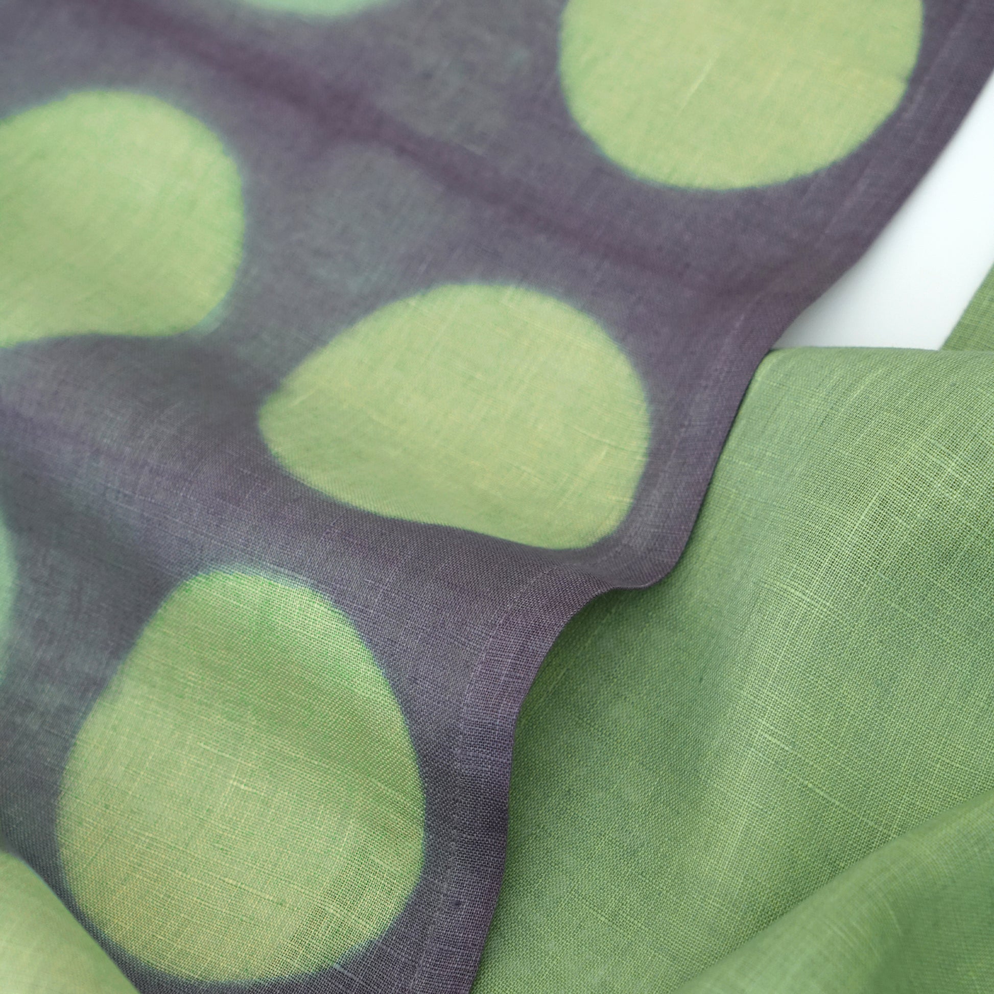 Hand dyed linen noren curtain in purple and green, hanging in a doorway as a room divider