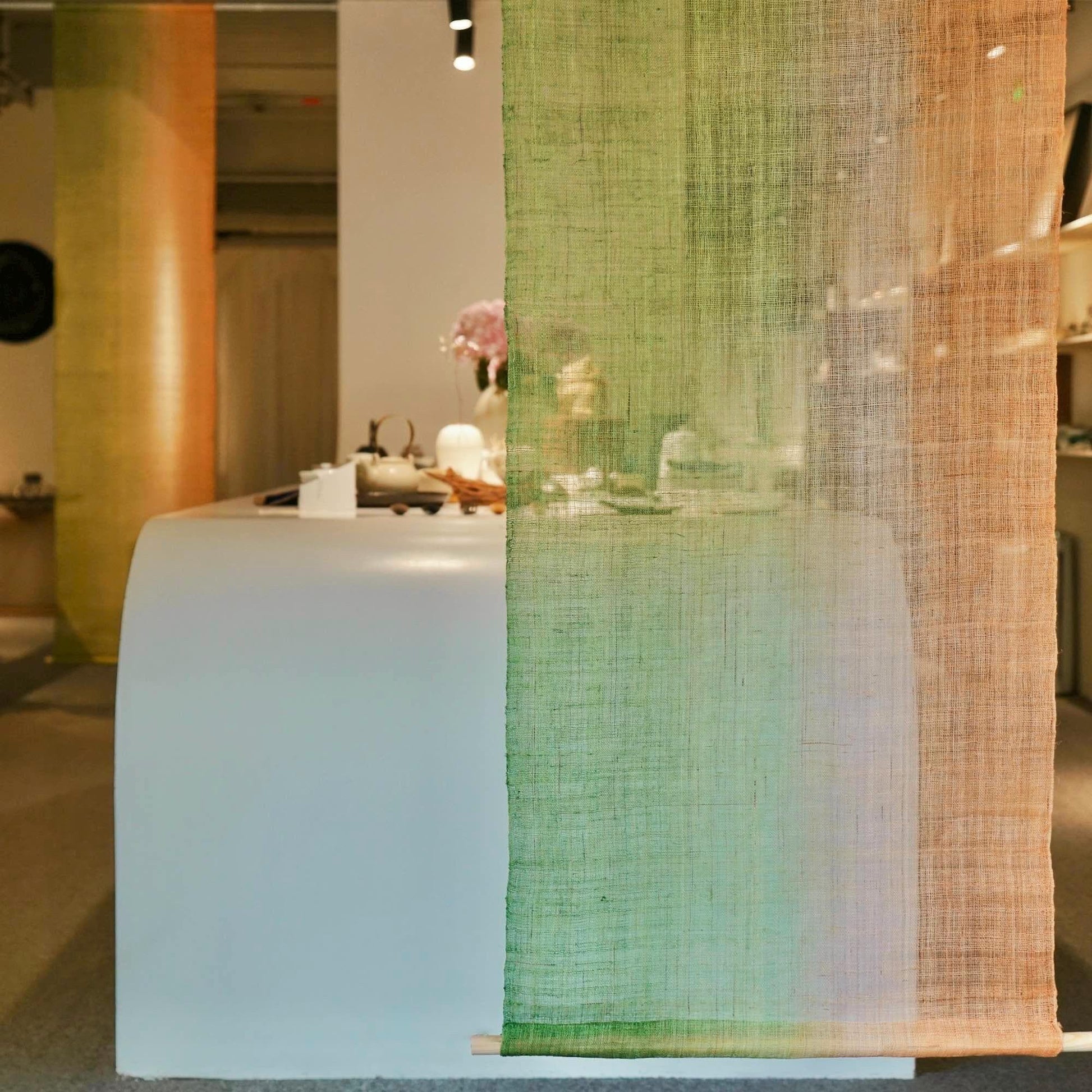 room scene featuring Ramie Ombre — Olive Haze hung by a window or doorway