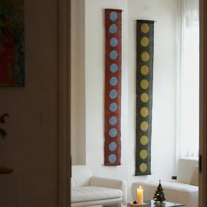 Narrow Ramie — Circles displayed vertically on a wall as a decorative textile banner
