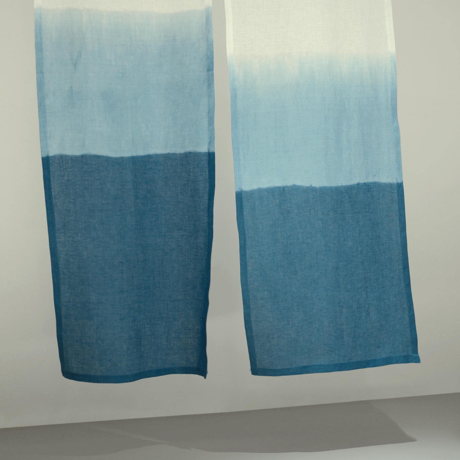 styled room scene with Soft Tone Noren — Mist Blue used as a window or doorway curtain