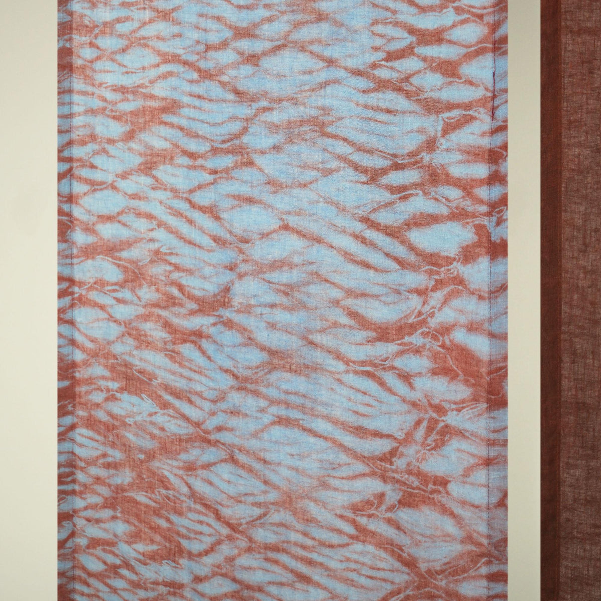 detail view of Motif Linen Noren — Mist Red showing plant-dyed linen texture and pattern