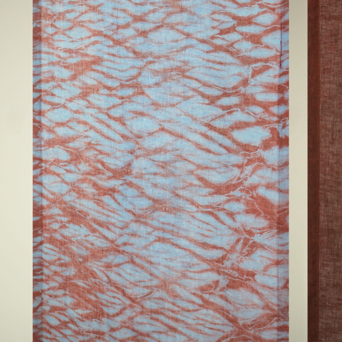 detail view of Motif Linen Noren — Mist Red showing plant-dyed linen texture and pattern