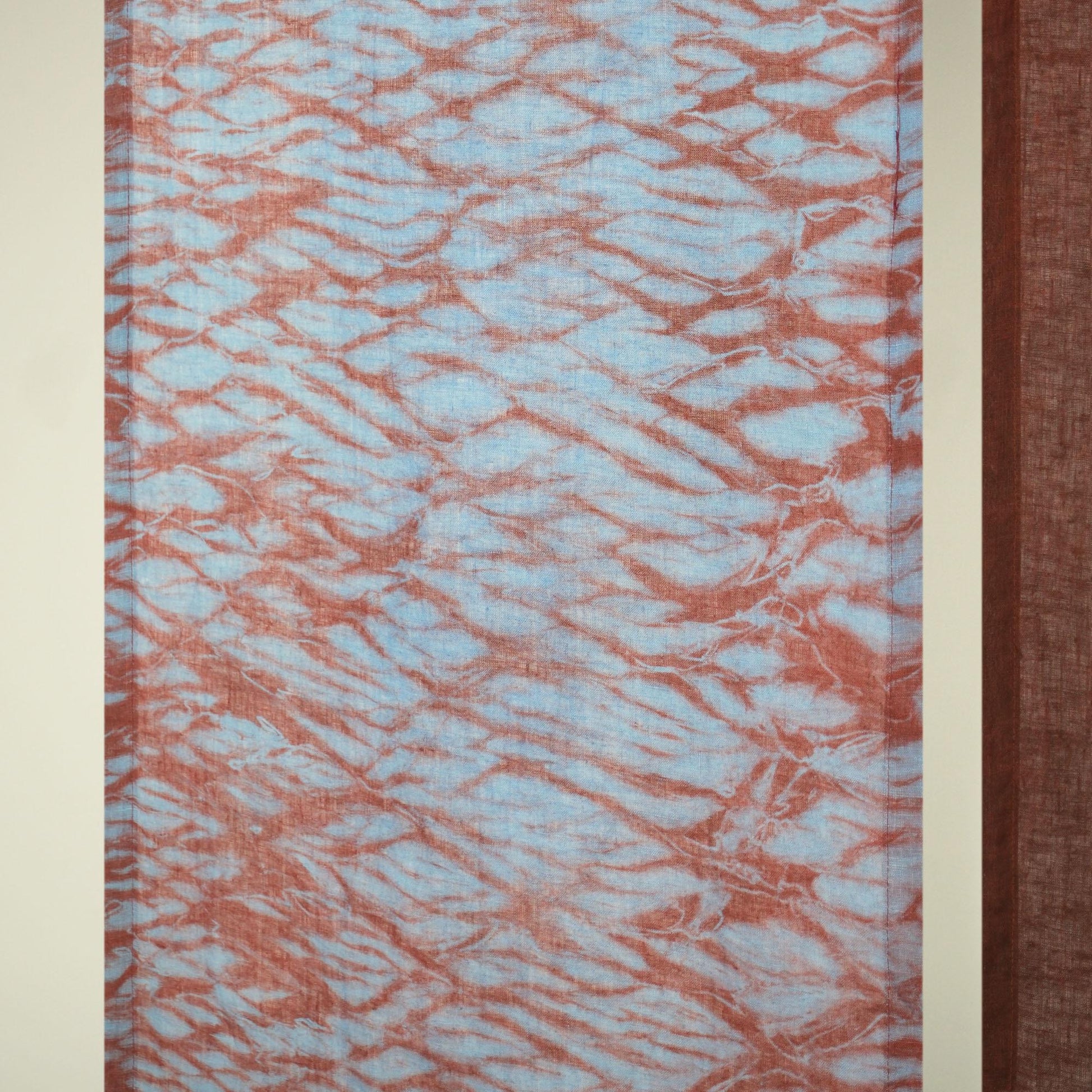 detail view of Motif Linen Noren — Mist Red showing plant-dyed linen texture and pattern