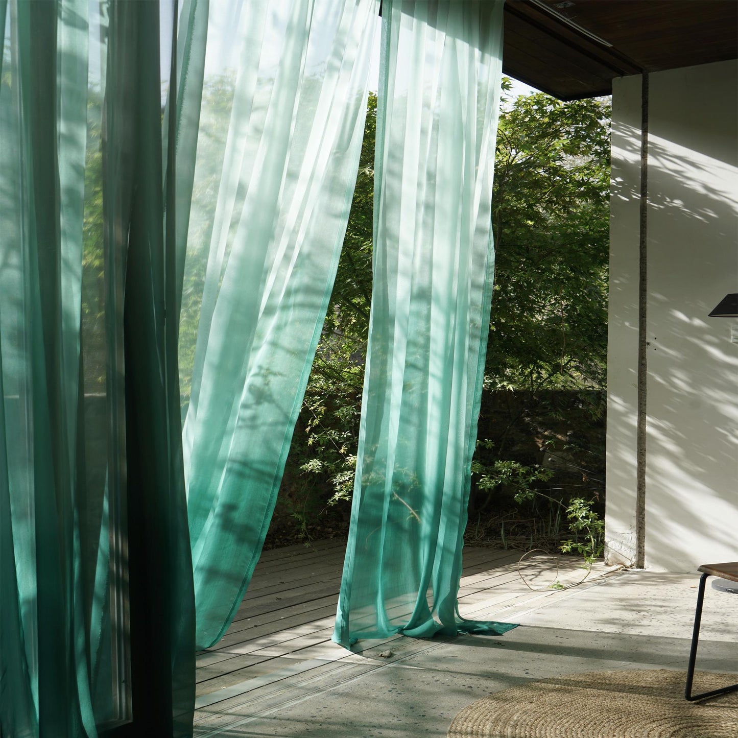 Sheer Curtain — Emerald Blue shown in a bedroom or living room setting