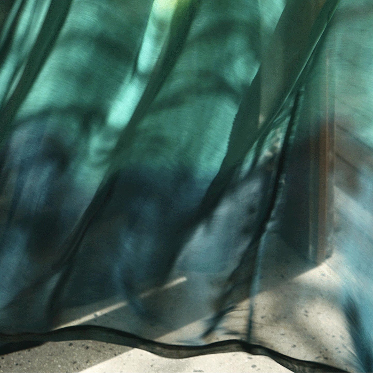 Sheer Curtain — Emerald Blue hung as window curtains in a bright room