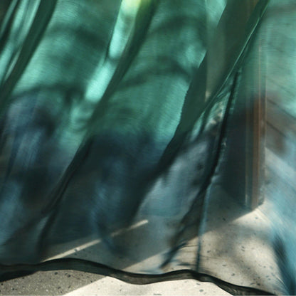 Sheer Curtain — Emerald Blue hung as window curtains in a bright room