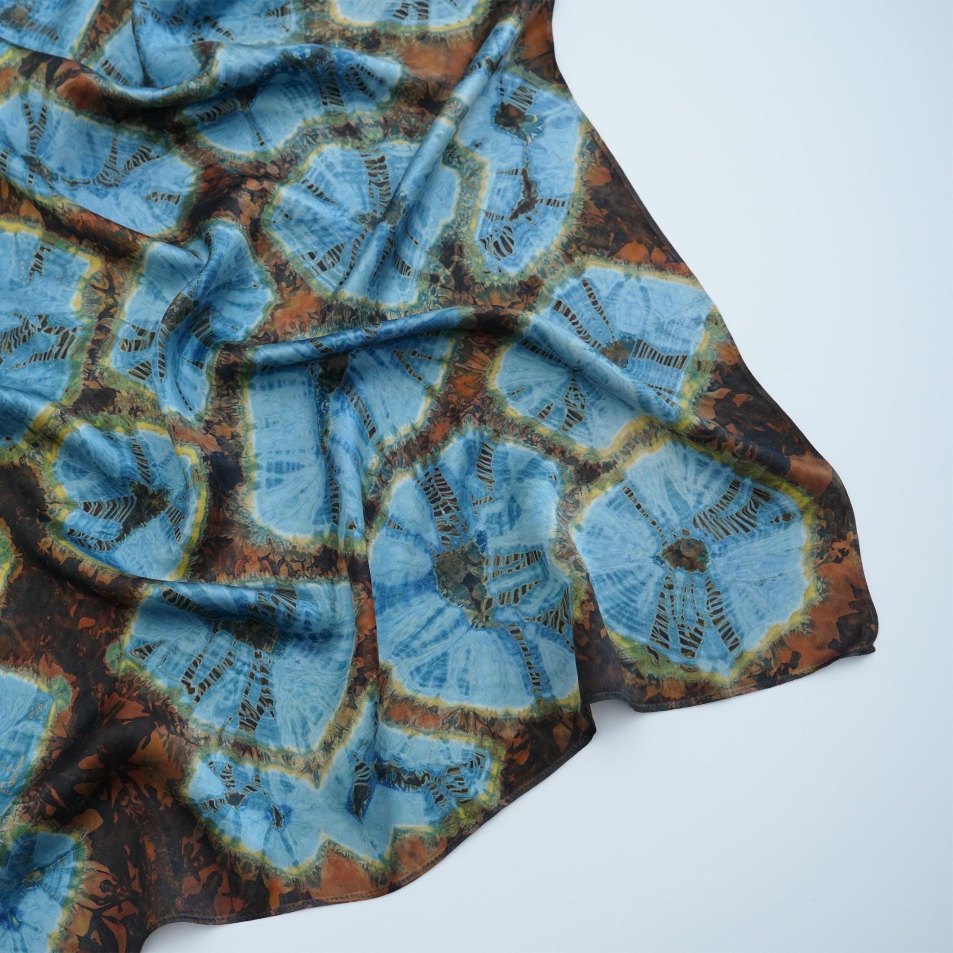 close-up of Scarf — Aqua Bloom showing the soft weave and botanical color