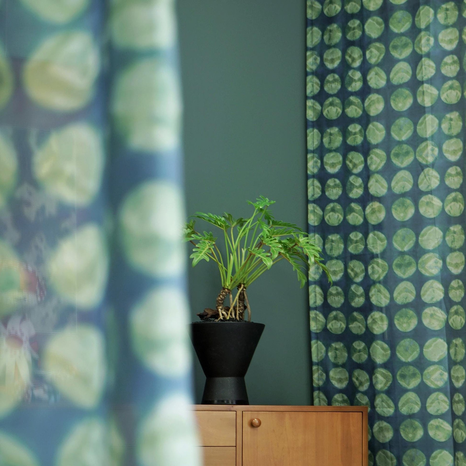 lifestyle scene with Pattern Drapery — Green Ochre creating a soft, airy room partition