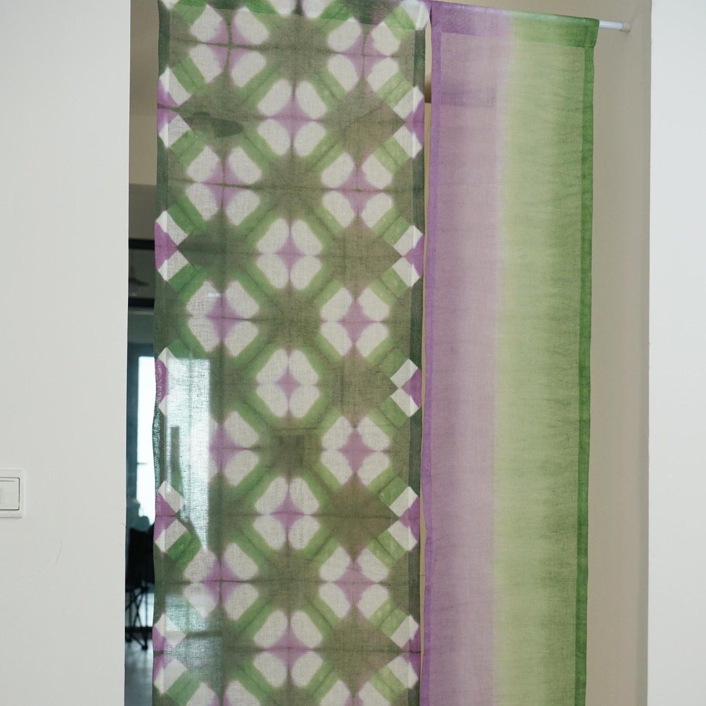 close-up of Motif Linen Noren — Purple Green showing the natural resist-dye motif on linen