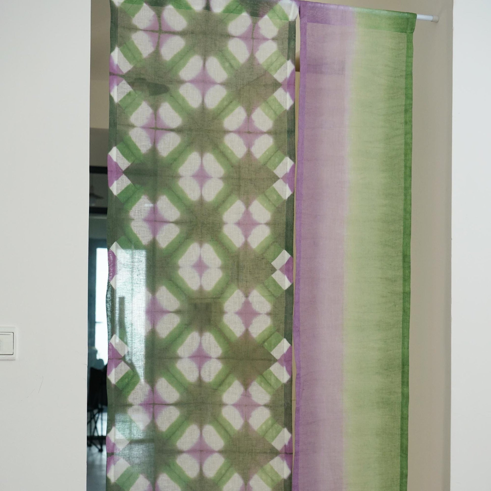 close-up of Motif Linen Noren — Purple Green showing the natural resist-dye motif on linen