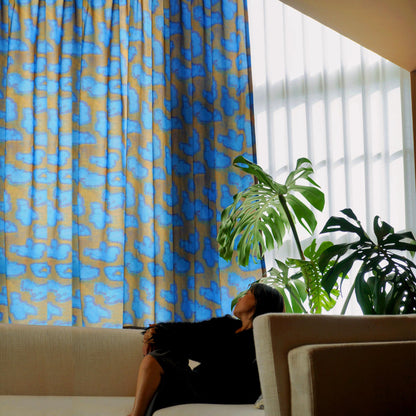 lifestyle scene with Pattern Drapery — Deep Blue creating a soft, airy room partition