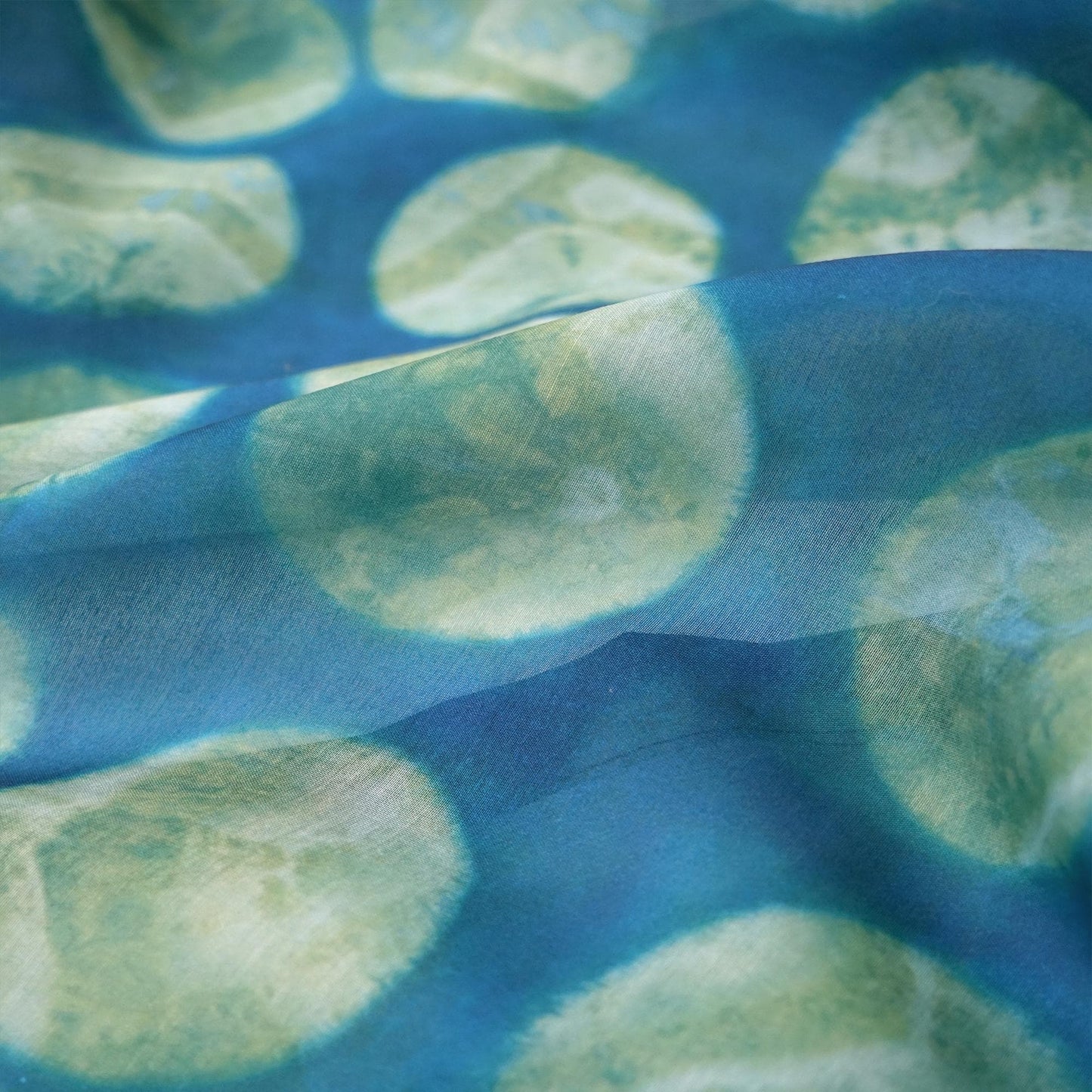 detail view of Pattern Drapery — Green Ochre showing plant-dyed pattern and sheer drape