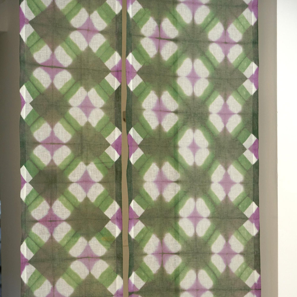 close-up of Motif Linen Noren — Green Flower showing the natural resist-dye motif on linen