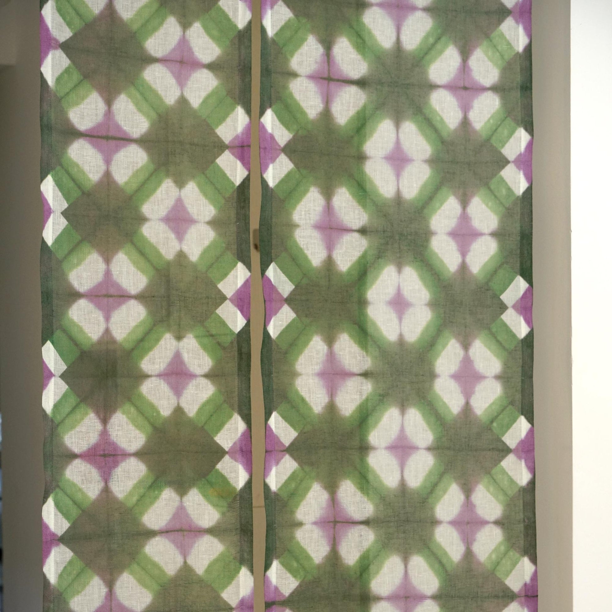 close-up of Motif Linen Noren — Green Flower showing the natural resist-dye motif on linen