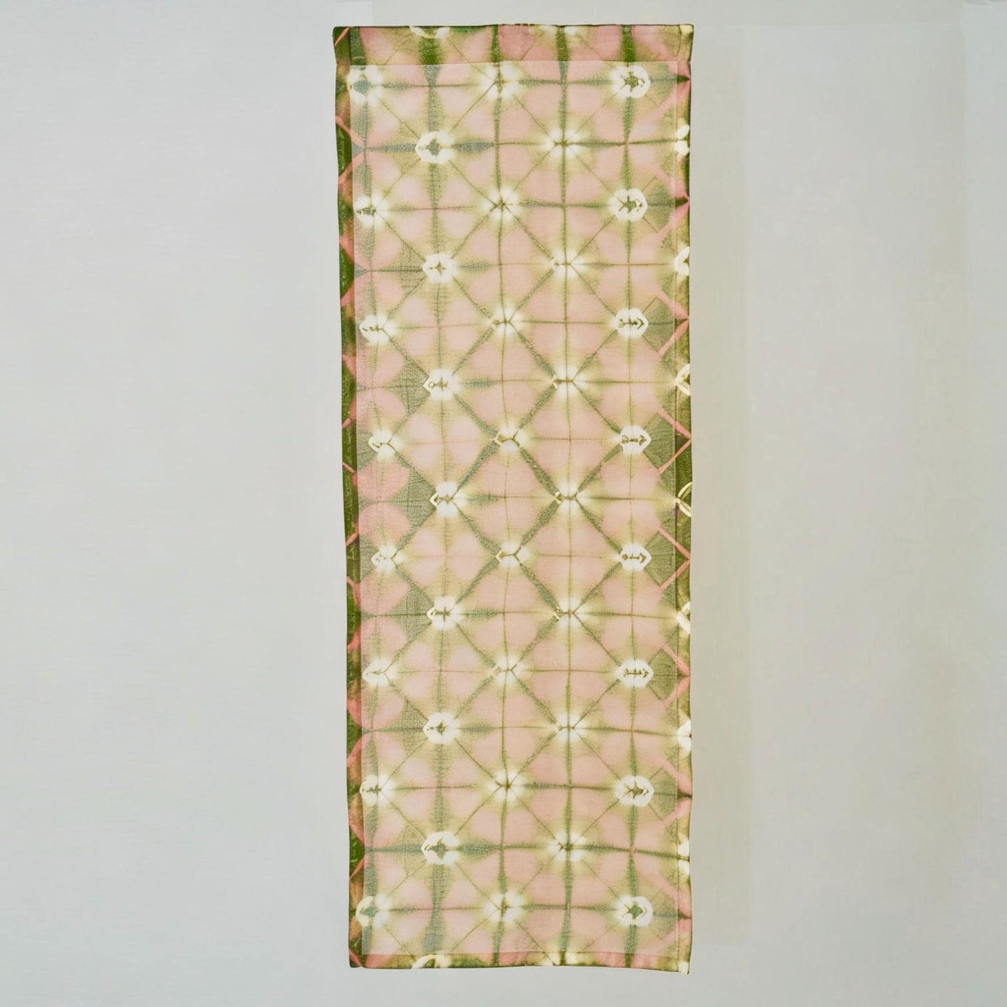 close-up of Motif Linen Noren — Peach showing the natural resist-dye motif on linen