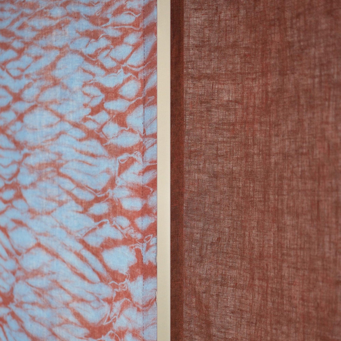 alternate angle of Motif Linen Noren — Mist Red hanging as a two-panel doorway curtain