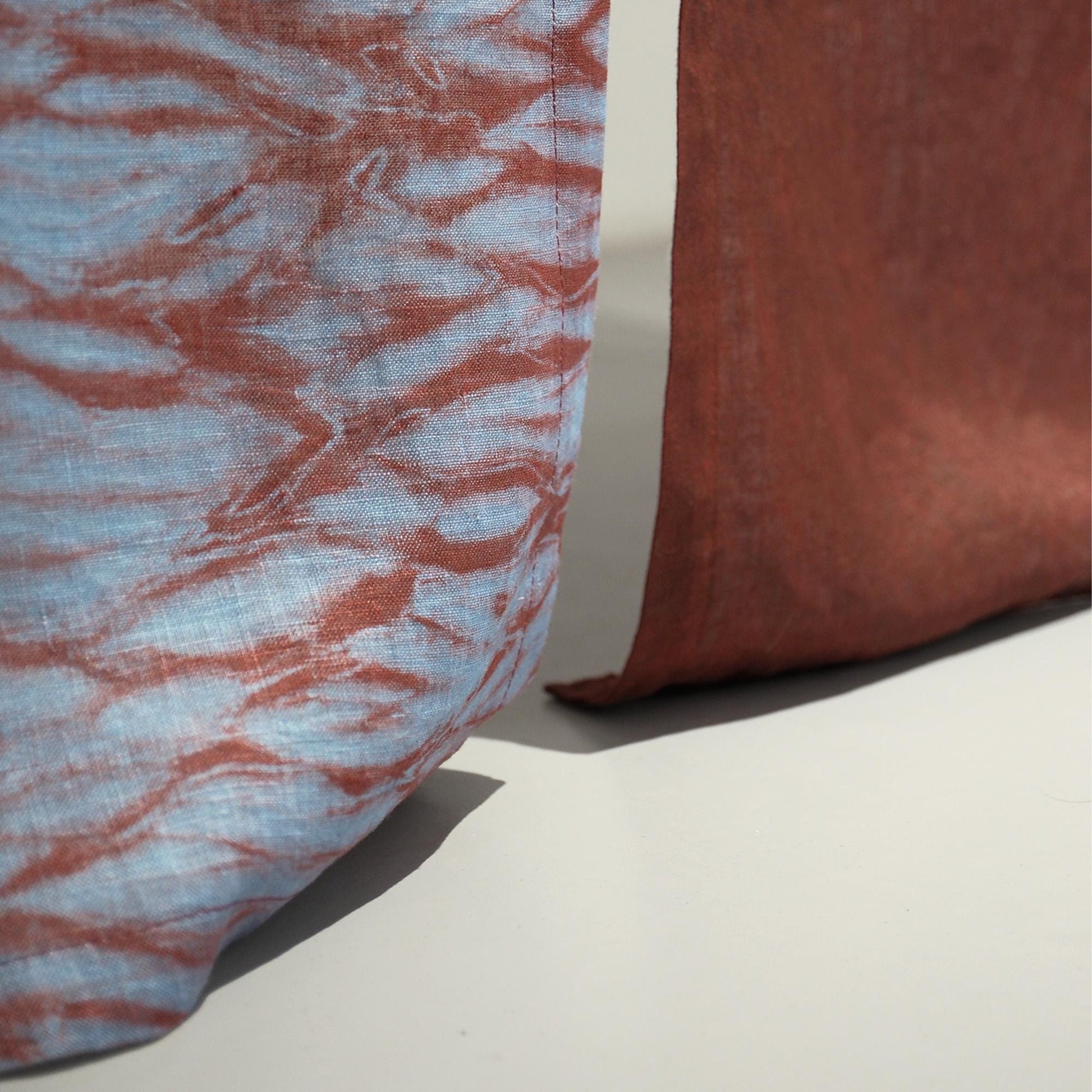 close-up of Motif Linen Noren — Mist Red showing the natural resist-dye motif on linen