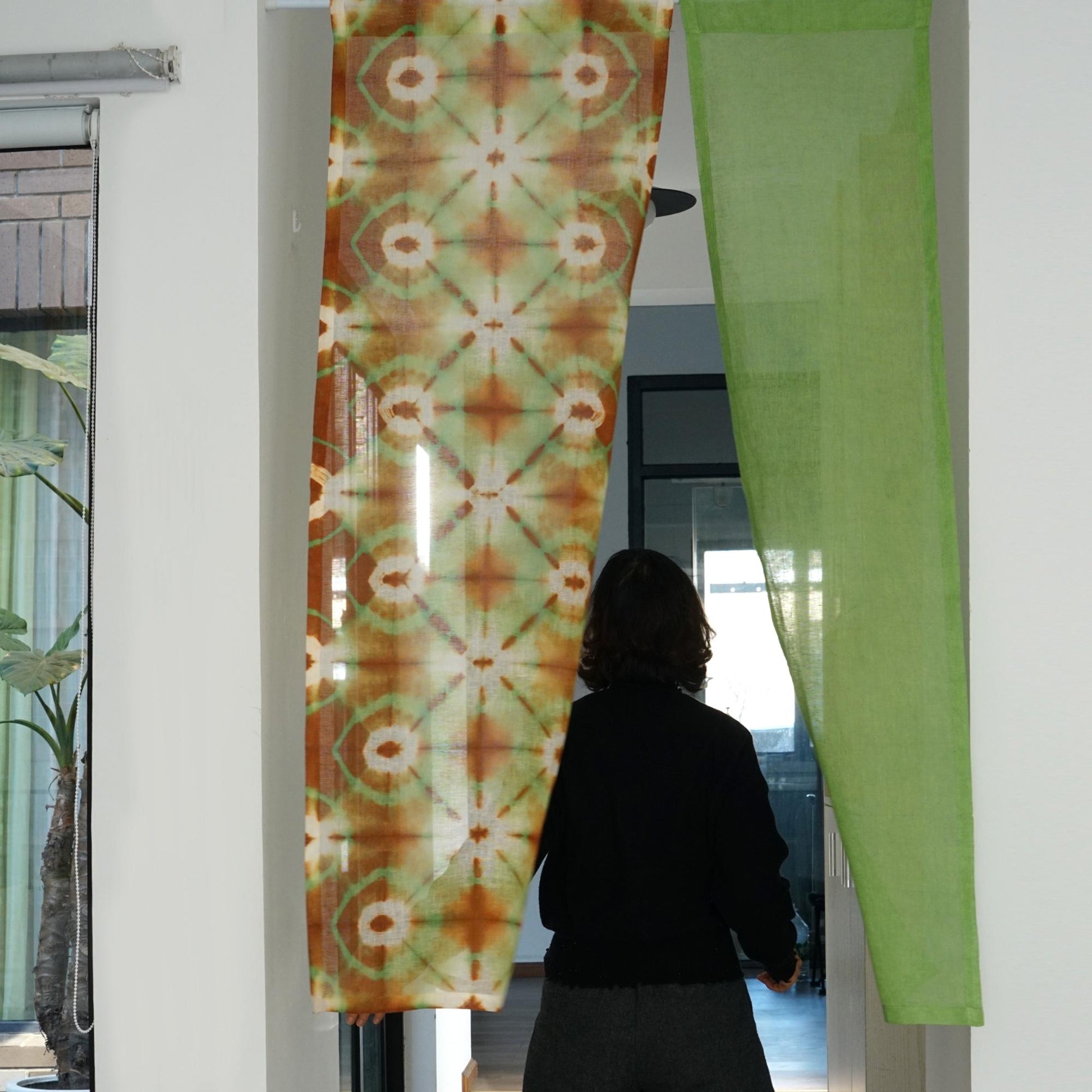 alternate angle of Motif Linen Noren — Green Bloom hanging as a two-panel doorway curtain