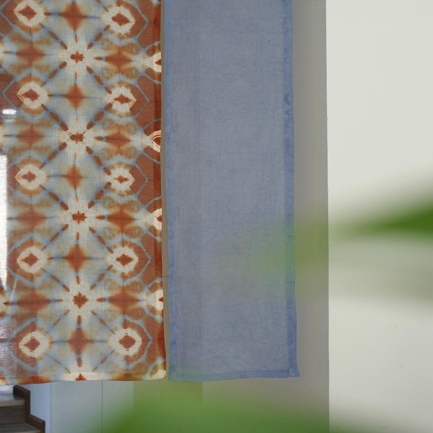 alternate angle of Motif Linen Noren — Blue Bloom hanging as a two-panel doorway curtain