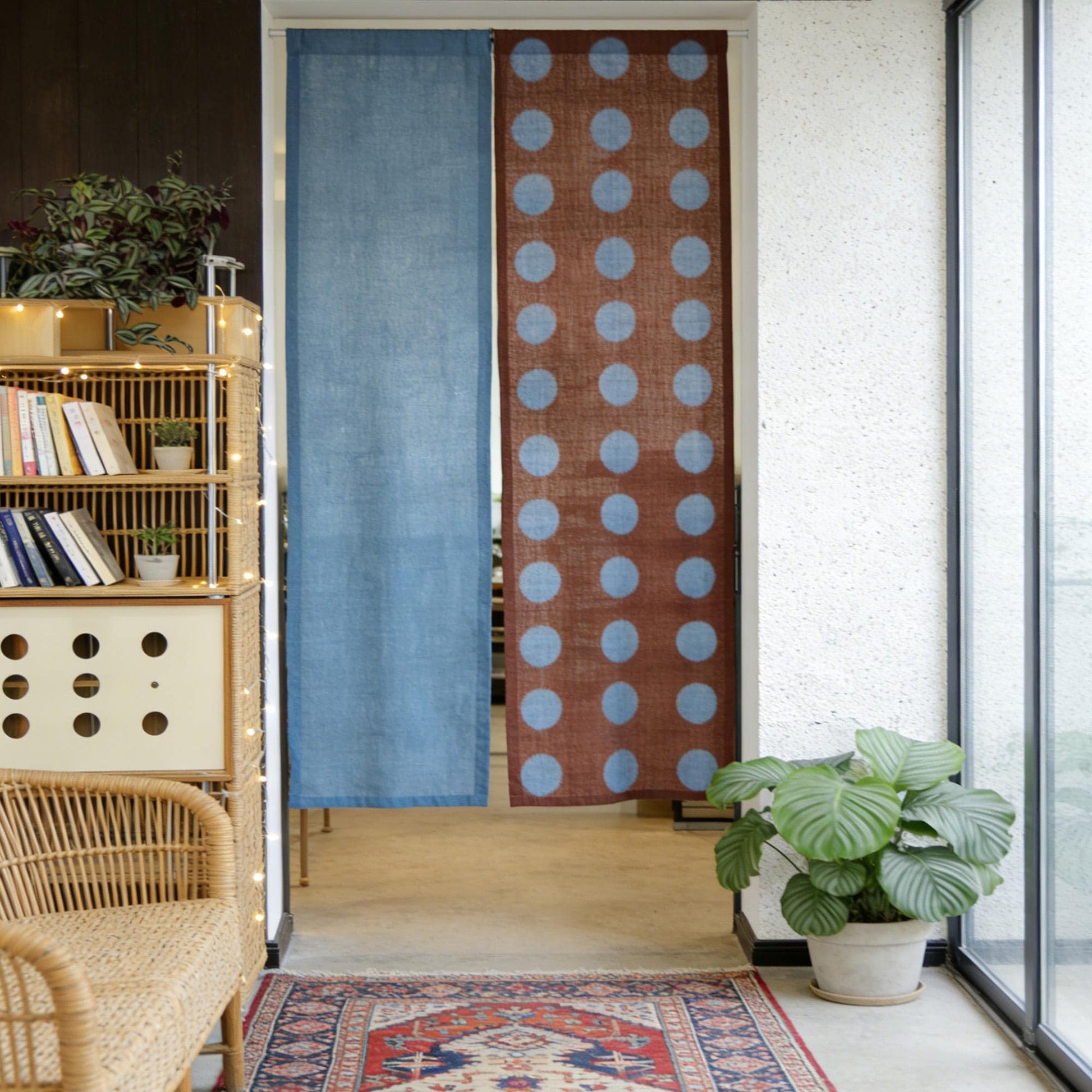 alternate angle of Polka Dot Linen Noren — Rust / Blue hanging as a two-panel doorway curtain