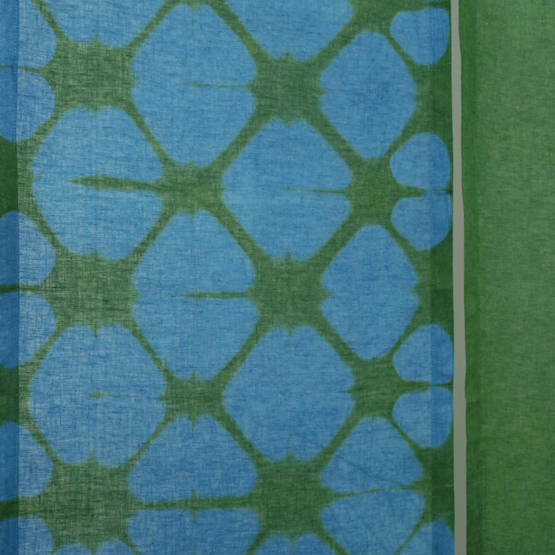 close-up of Motif Linen Noren — Plaid showing the natural resist-dye motif on linen