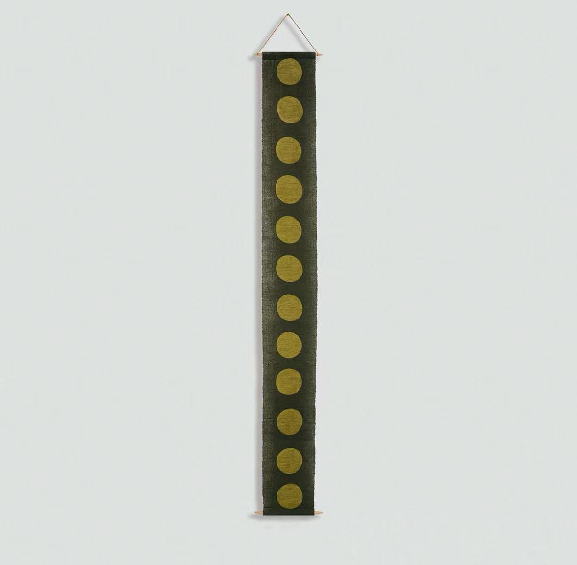 Narrow Ramie — Circles displayed vertically on a wall as a decorative textile banner