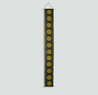 Narrow Ramie — Circles displayed vertically on a wall as a decorative textile banner
