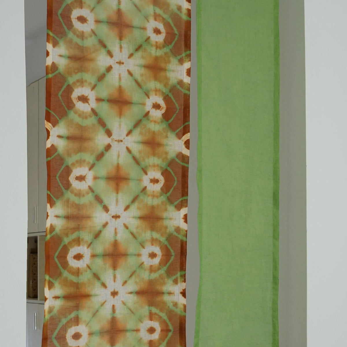 close-up of Motif Linen Noren — Green Bloom showing the natural resist-dye motif on linen