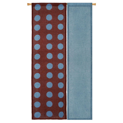 alternate angle of Polka Dot Linen Noren — Rust / Blue hanging as a two-panel doorway curtain