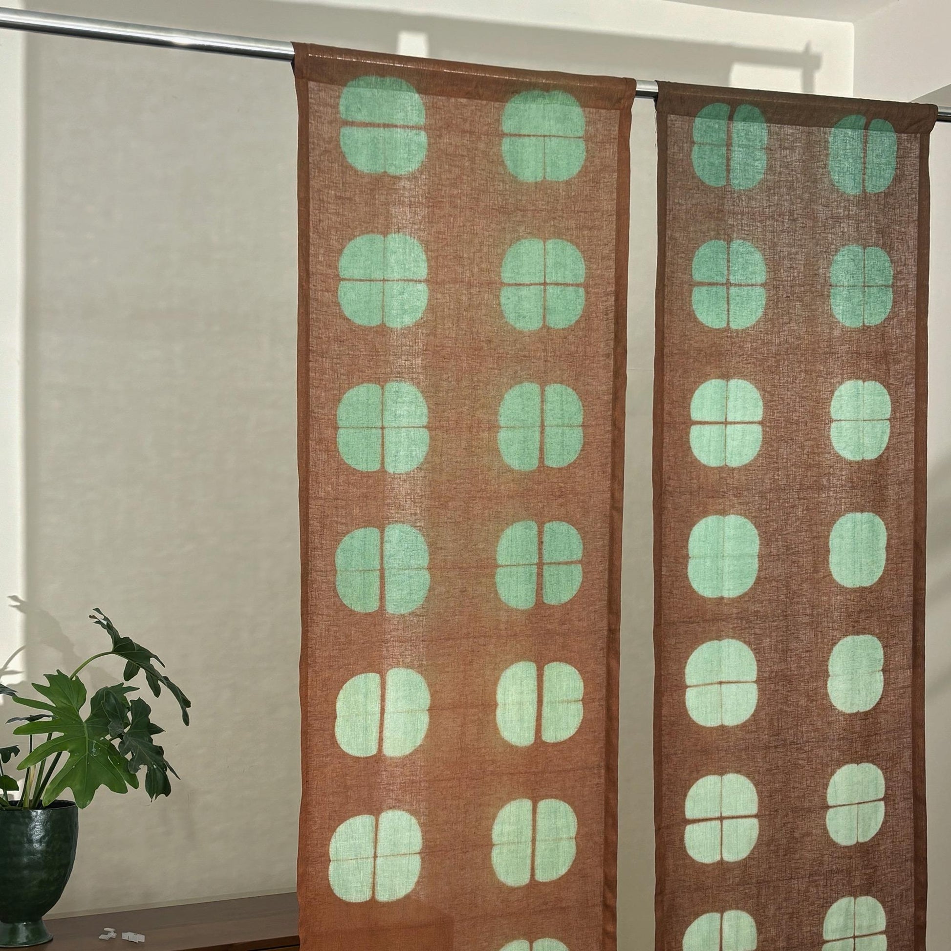 alternate angle of Motif Linen Noren — Amber Grid hanging as a two-panel doorway curtain