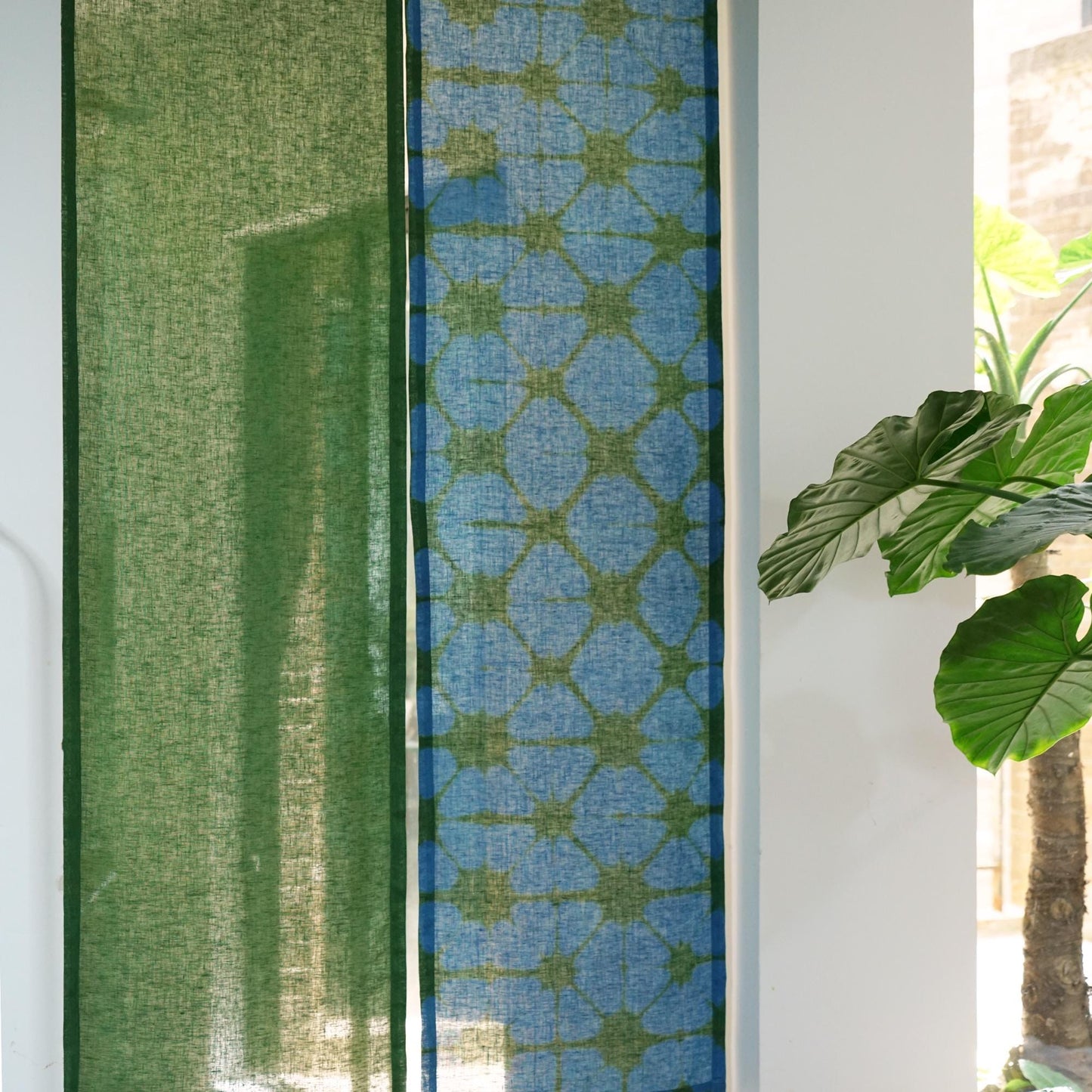alternate angle of Motif Linen Noren — Plaid hanging as a two-panel doorway curtain
