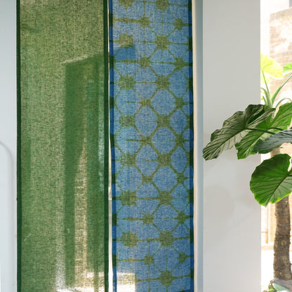 alternate angle of Motif Linen Noren — Plaid hanging as a two-panel doorway curtain